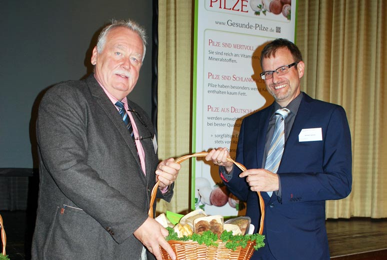 Michael Legrand, rechts, freut sich über einen großen Korb mit frischen Pilzen aus der Hand des BDC-Vorsitzenden Michael Schattenberg.